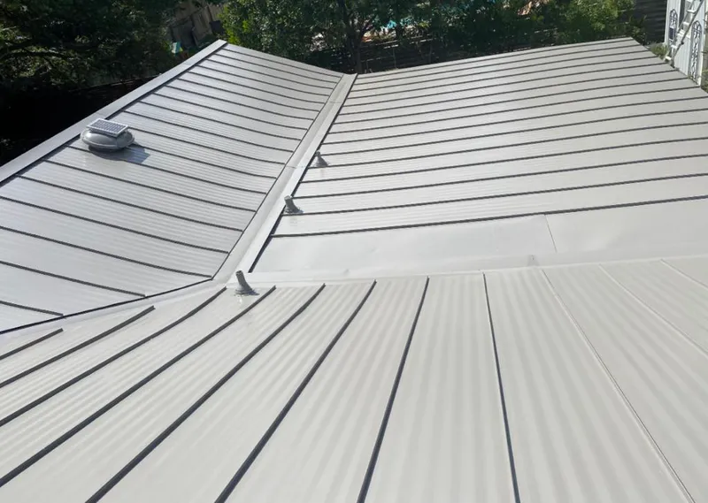 Solar attic fan installed on a metal roof for Roof Ventilation in Friendswood